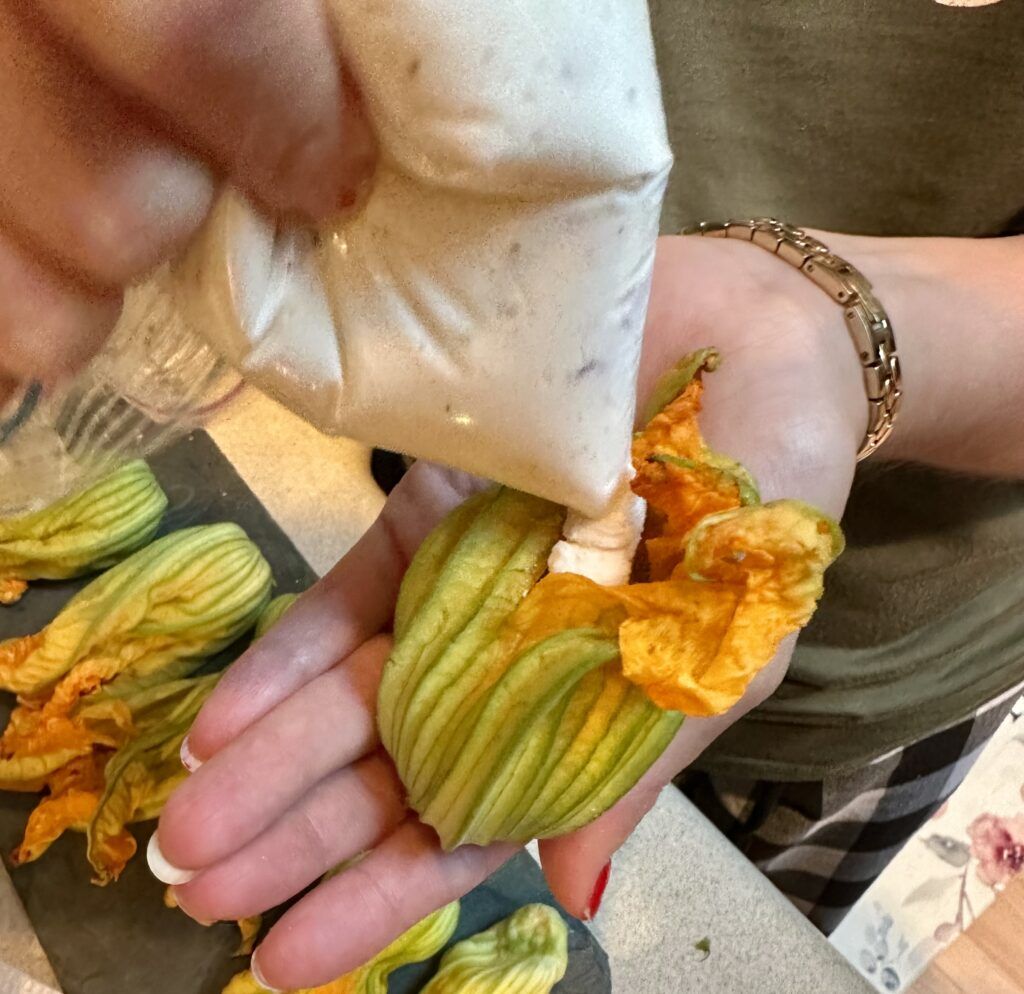 Stuffing the zucchini flowers with the ricotta