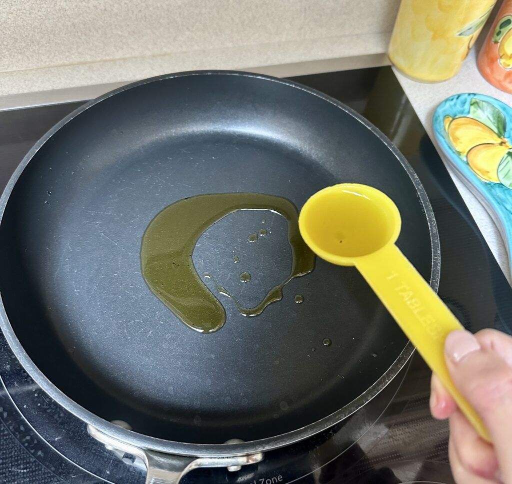 Adding the olive oil in the pan