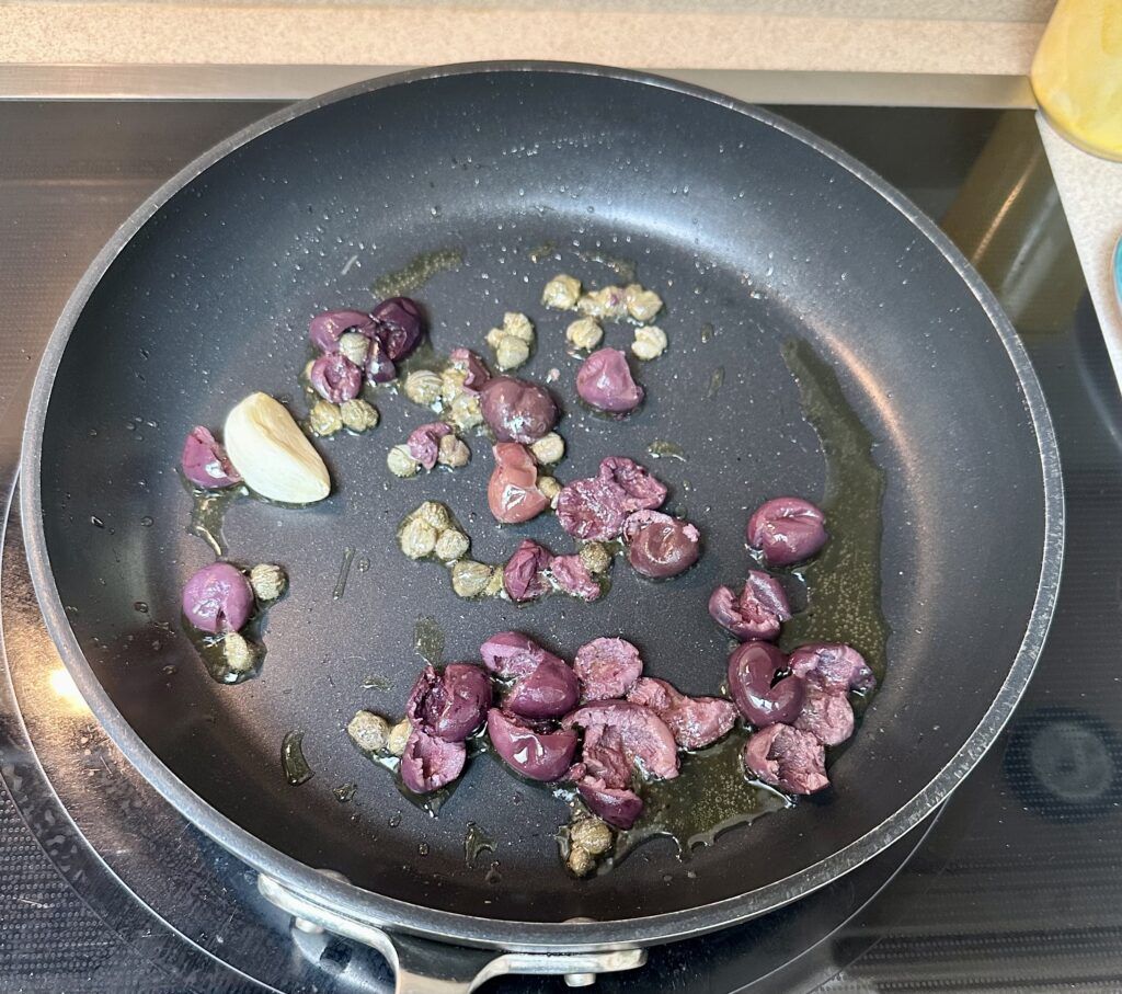 Adding the olives, cappers and garlic